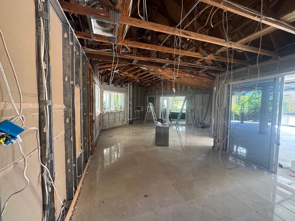 Long interior view with ceiling finishes removed and framing exposed