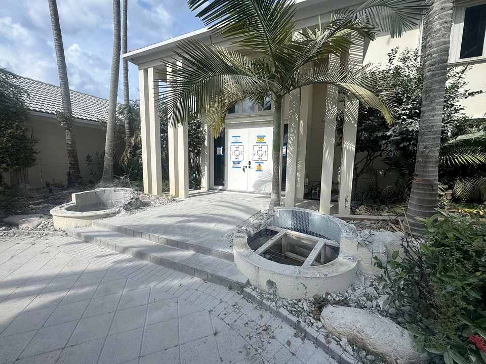 Entry after exterior wall demolition with existing fountain basins still visible
