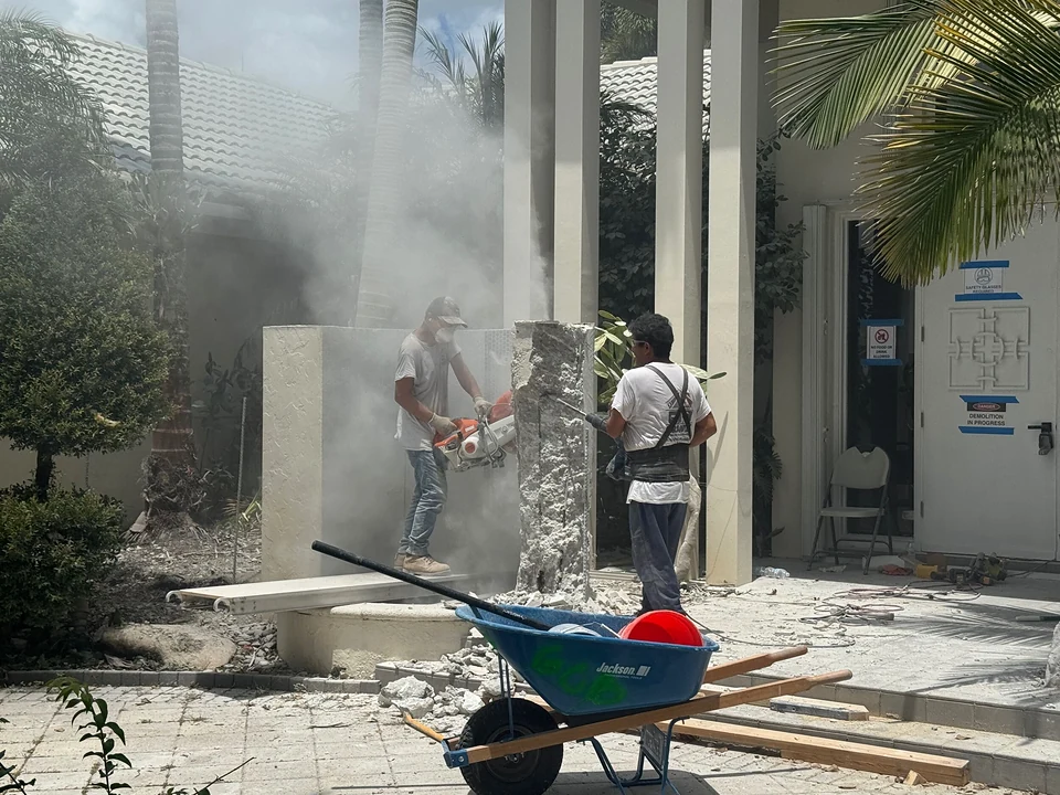 GCB crew removing exterior entry wall finishes during demolition