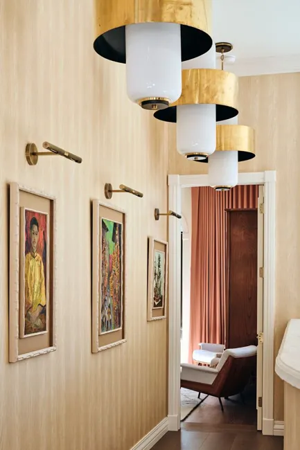Layered lighting and artwork along the hallway