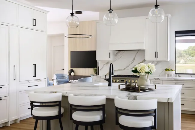 Kitchen island, cabinetry, and pendant lighting