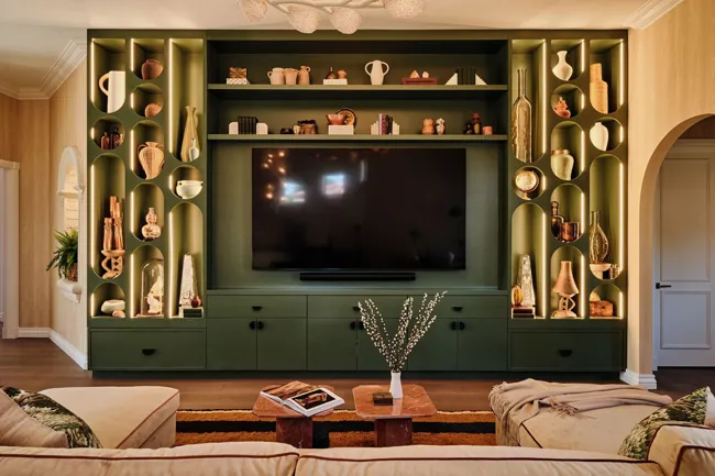 Custom green cabinetry and integrated media wall