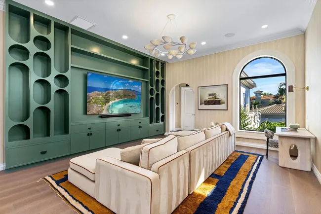 Living room with curved cabinetry and patterned floor finishes