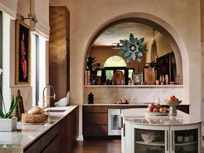 Kitchen framed by an arched opening