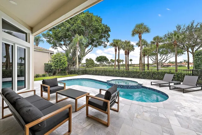 Covered terrace overlooking a pool and landscape
