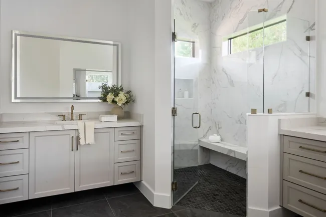 Primary bathroom with coordinated stone and cabinetry