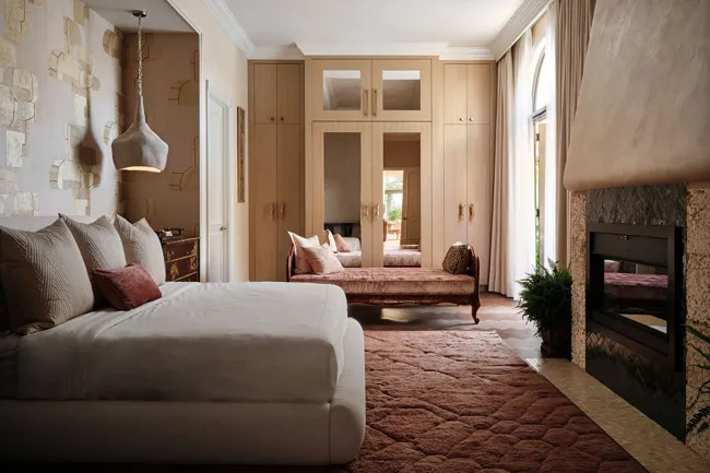 Bedroom with integrated millwork and fireplace